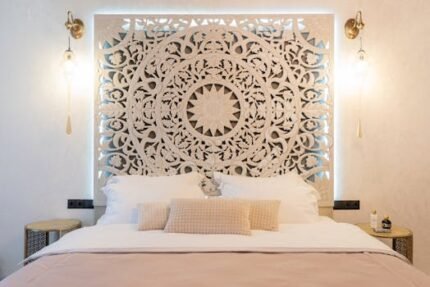 Modern bedroom featuring a beautifully carved wooden headboard, soft bedding, and elegant lighting.